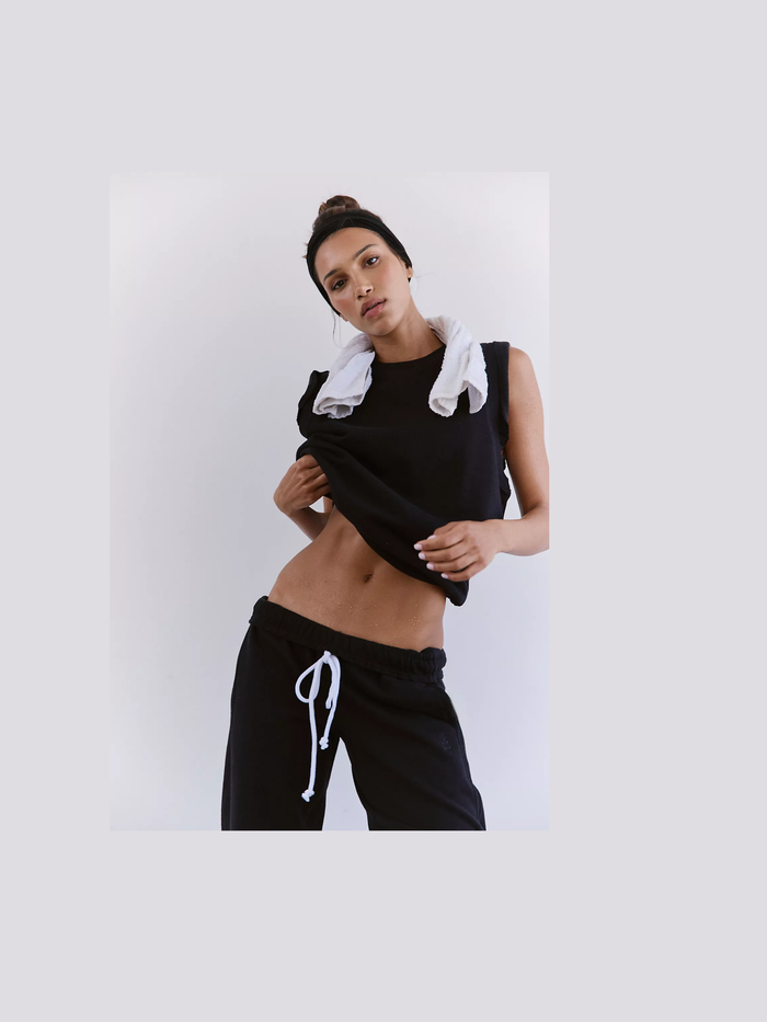 Close-up of black tank top flutter sleeve detail