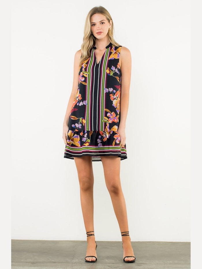 Front view of black floral print mini dress featuring V-neckline, gathered collar, and striped center panel