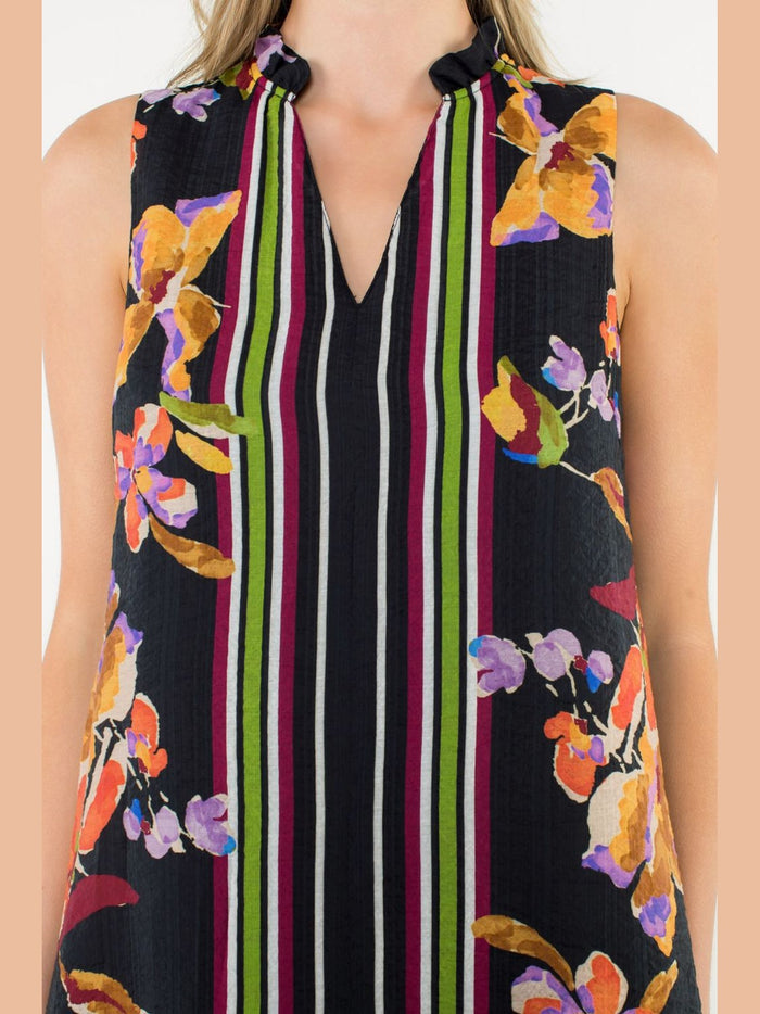 Close-up of black floral mini dress bodice showing keyhole neckline, crinkled fabric texture, and vibrant flower details