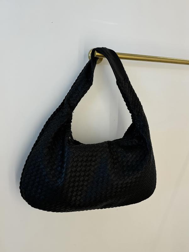Black woven slouch handbag with grid texture and gold strap